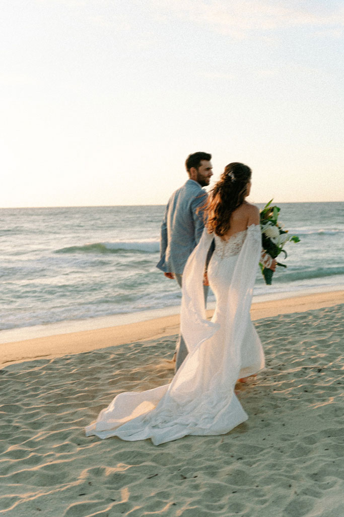 Destination beach wedding couple at sunset in Cabo, editorial wedding photography