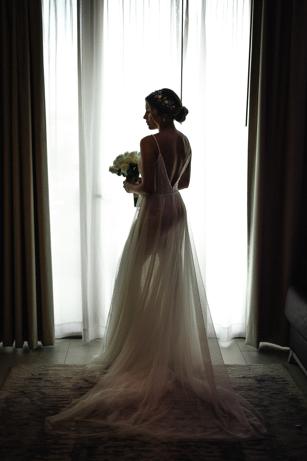bride getting ready silhouette by window natural light Cancun wedding